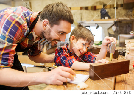 dad and son with ruler measuring plank at workshop dad and son with ruler measuring plank at workshop 25281858