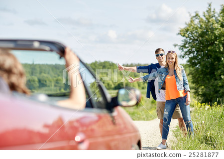 couple hitchhiking and stopping car on countryside couple hitchhiking and stopping car on countryside 25281877
