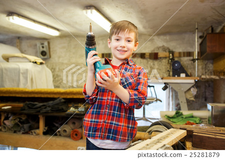 happy little boy with drill at workshop 25281879