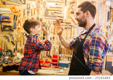 father and little son making high five at workshop father and little son making high five at workshop 25281883