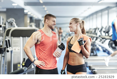 smiling man and woman talking in gym smiling man and woman talking in gym 25281929