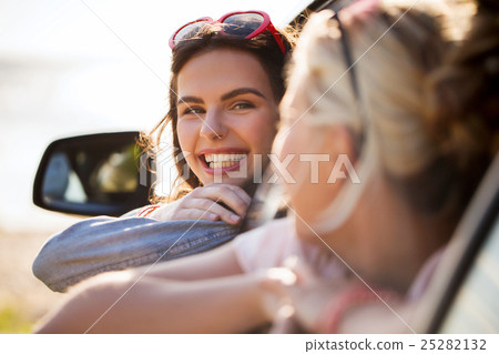 happy teenage girls or women in car at seaside happy teenage girls or women in car at seaside 25282132