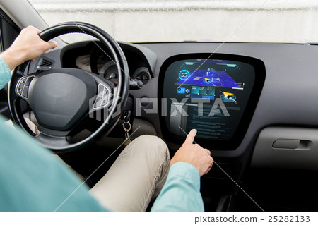 close up of man driving car with navigation system close up of man driving car with navigation system 25282133