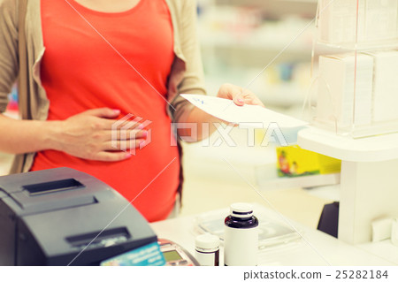 pregnant woman buying medication at pharmacy pregnant woman buying medication at pharmacy 25282184