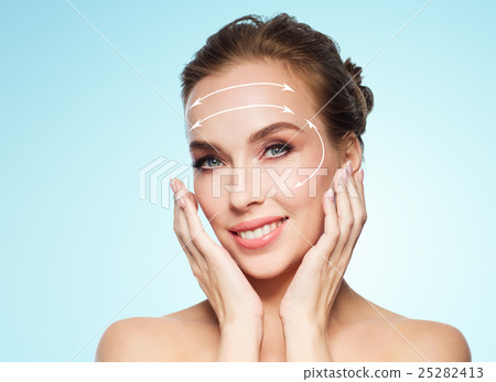 beautiful young woman touching her face beautiful young woman touching her face 25282413