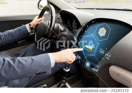 close up of man driving car with diagram on screen 25283172