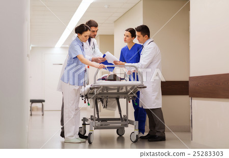 medics with woman on hospital gurney at emergency 25283303