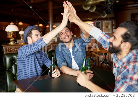 men with beer making high five at bar or pub 25283708