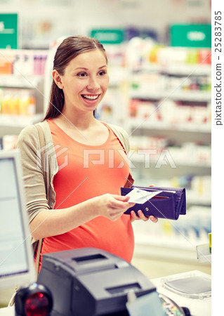 pregnant woman with wallet at cashbox in drugstore pregnant woman with wallet at cashbox in drugstore 25283785
