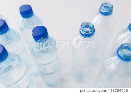 close up of bottles with drinking water on table close up of bottles with drinking water on table 25284426