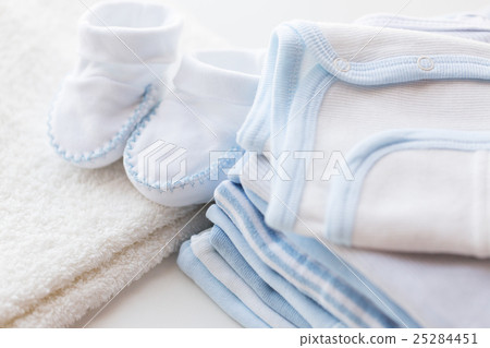 close up of baby boys clothes for newborn on table 25284451