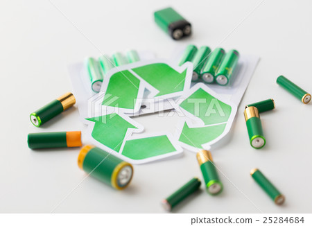 close up of batteries and green recycling symbol close up of batteries and green recycling symbol 25284684