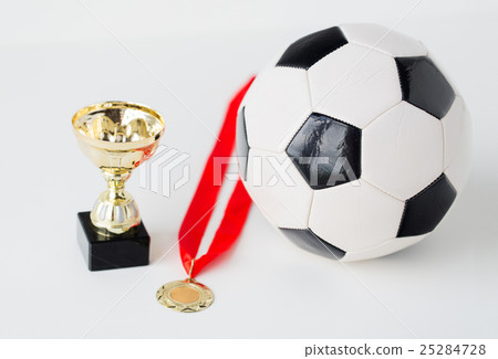 close up of football ball, golden cup and medal 25284728