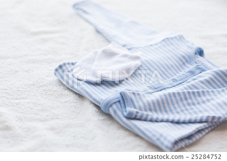close up of baby boys clothes for newborn on table 25284752