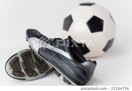 close up of soccer ball and football boots 25284758