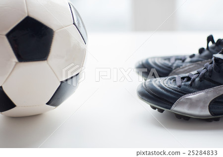 close up of soccer ball and football boots 25284833
