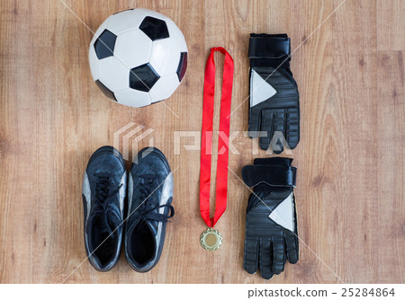 close up of soccer ball, boots, gloves and medal 25284864