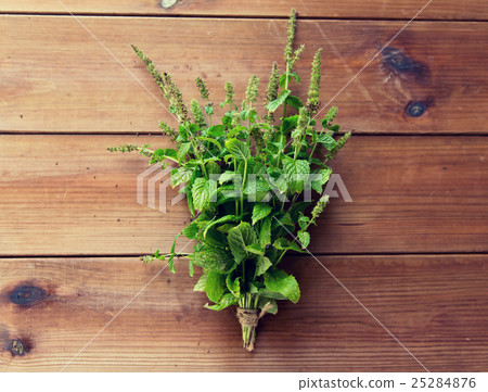 close up of fresh melissa bunch on wooden table 25284876