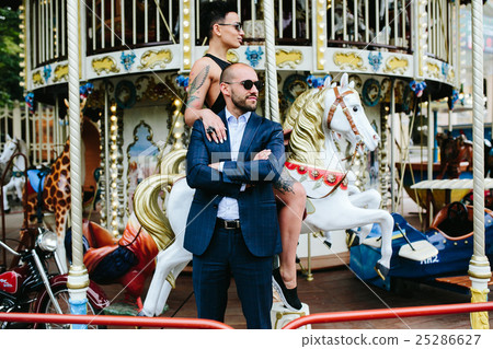 adult man and woman on a carousel adult man and woman on a carousel 25286627