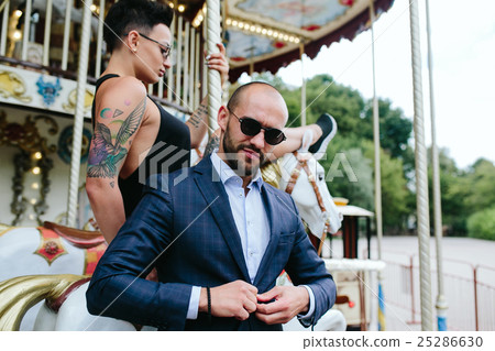 adult man and woman on a carousel 25286630