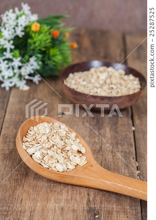 oats in spoon on wood table oats in spoon on wood table 25287525