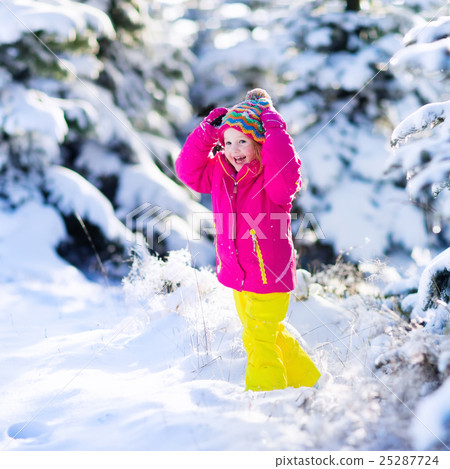 Child having fun in snowy winter park Child having fun in snowy winter park 25287724