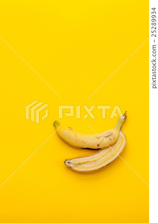 Peel banana and fruit on a yellow background Peel banana and fruit on a yellow background 25289934