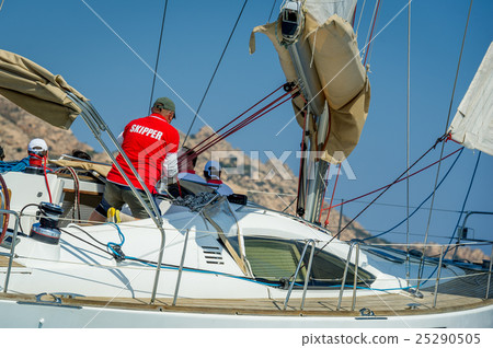 Skipper is working on his sailing boat during the Skipper is working on his sailing boat during the 25290505