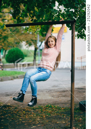 happy girl swinging on the crossbar 25292042