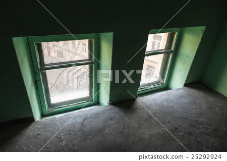Two small windows in green wall, urban interior 25292924