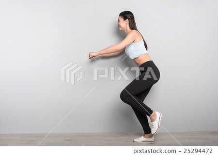 Positive woman doing sport exercises 25294472