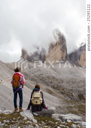 two girls hikers looking at the rocks 25295122