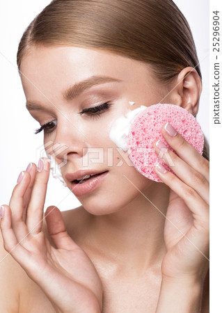 Beautiful young girl with sponge and foam cleanser 25296904