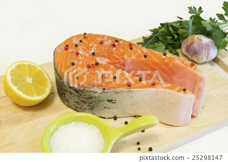 Row salmon with pepper and salt on a board 25298147