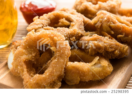 Fresh onion gings on a wooden board 25298395