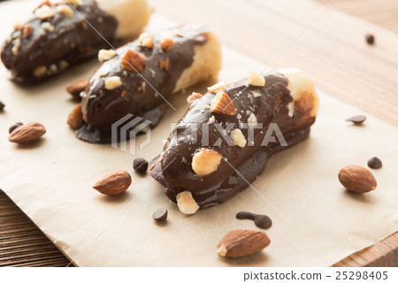 Mini chocolate covered frozen bananas with almonds 25298405