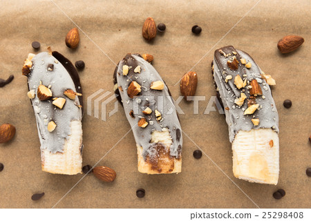 Mini chocolate covered frozen bananas with almonds 25298408