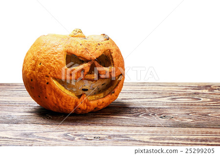rotten and angry pumpkin lantern jack on a wooden 25299205