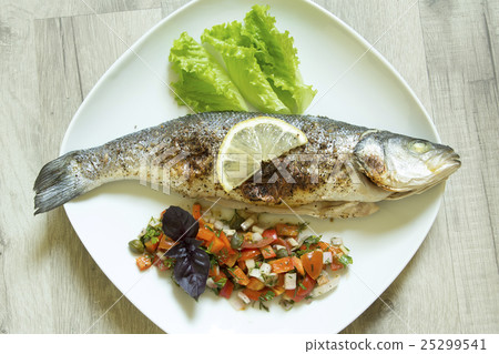 Baked seabass on a plate with vegetables Baked seabass on a plate with vegetables 25299541