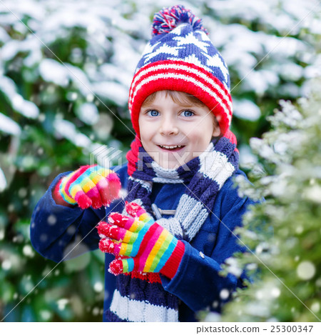 Happy kid boy having fun with snow in winter Happy kid boy having fun with snow in winter 25300347