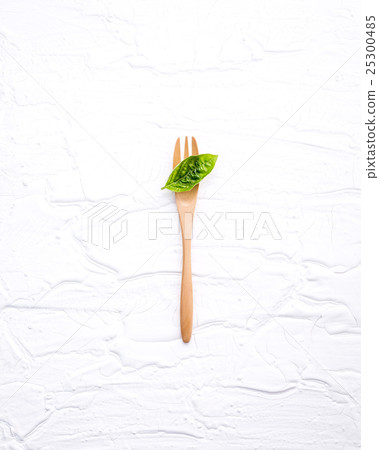 Closeup  fresh sweet basil leaves with fork   25300485
