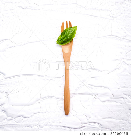 Closeup  fresh sweet basil leaves with fork  25300486