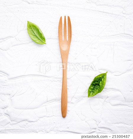 Closeup  fresh sweet basil leaves with fork   25300487