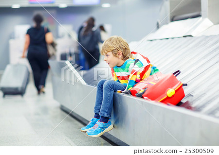 little tired kid boy at the airport, traveling 25300509