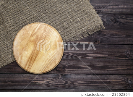 Cutting board on wooden table, top view Cutting board on wooden table, top view 25302894