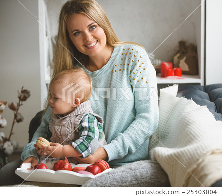 Mother and her son sitting on the sofa at home Mother and her son sitting on the sofa at home 25303004