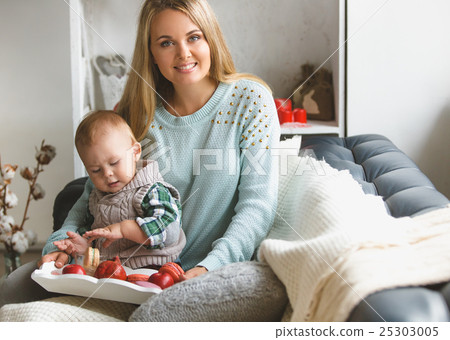 Mother and her son sitting on the sofa at home Mother and her son sitting on the sofa at home 25303005