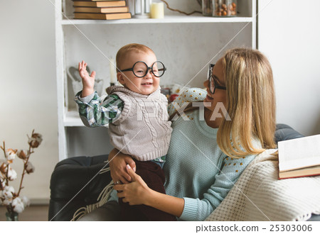Mother and her son reading book at home Mother and her son reading book at home 25303006