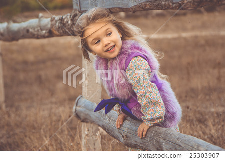 Happy child girl in autumn filed Happy child girl in autumn filed 25303907