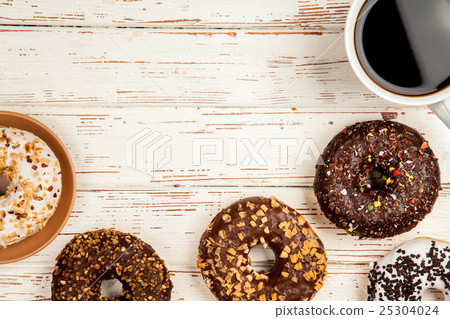 Tasty donuts on white wood background 25304024
